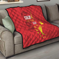 Red quilt on living room sofa, China 2024 text and golden dragon swirl with yellow stars