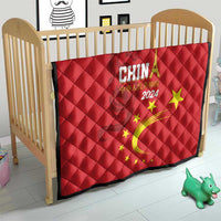 Red quilt on wooden crib, China 2024 design with golden dragon swirl and yellow stars