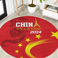Round red rug with gold dragon graphic, stars, Eiffel Tower, and “2024” text