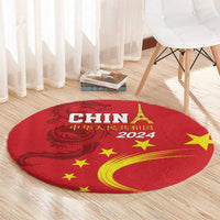 Round red rug with gold dragon and stars, “2024” near the center