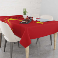 Red tablecloth with gold dragon and star design, draped over the table edges