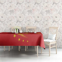 Red tablecloth featuring gold stars and curved dragon artwork across the table