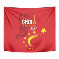 Red tapestry close-up showing dragon, CHINA 2024 text, gold stars and crescent moon