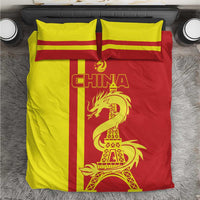 Red and yellow bedding set with CHINA lettering, dragon, and Eiffel Tower on duvet