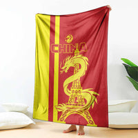 Draped China blanket with red-yellow vertical stripes and gold dragon with Eiffel Tower
