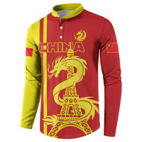 Red/yellow long-sleeve button polo with China text, dragon and Eiffel Tower front view