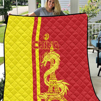 Red and yellow China-themed quilt with dragon and Eiffel Tower graphic, quilted pattern