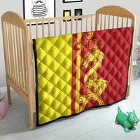Red and yellow China-themed quilt on a baby bed/crib with dragon and Eiffel Tower print