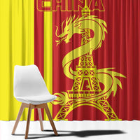 Close-up of red and yellow window curtain with gold dragon and Eiffel Tower graphic