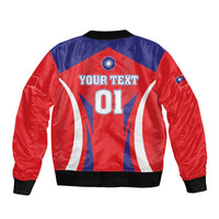 Back of red and blue bomber jacket with black ribbed hem, sports flag graphic and text