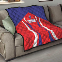 Quilted Taiwan flag blanket on a living room sofa, red shield and white wave stripes