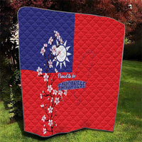 Folded red and blue quilt blanket showing Taiwan map, plum blossoms, and “Proud to be Taiwanese”