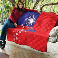 Red and blue quilt blanket draped over sofa with Taiwan map, plum blossoms, and “Proud to be Taiwanese”