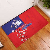 Red rubber doormat with blue corner panel, Taiwan outline, plum blossoms and “Proud to be Taiwanese”