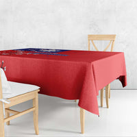 Red tablecloth draped over rectangular table with hanging corner