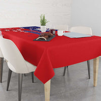 Red tablecloth on dining table with blue floral print border
