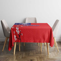 Red tablecloth with plum blossom branch and blue map panel on table