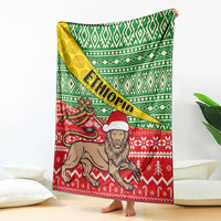 Ethiopian Christmas blanket with green diamond pattern, yellow diagonal band, and red lion scene