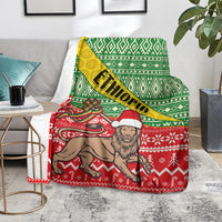 Ethiopian Christmas blanket featuring green geometric border and red patterned animal with beard