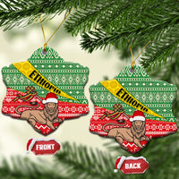 Snowflake-shaped ceramic Christmas ornaments with green red Ethiopian pattern and ETHIOPIA band, front/back.