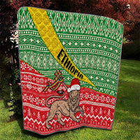 Green and red Ethiopian Christmas quilt with yellow sash, lion and festive zigzag motifs
