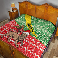 Ethiopian Christmas quilt on bed: green top, red bottom, yellow sash, lion artwork
