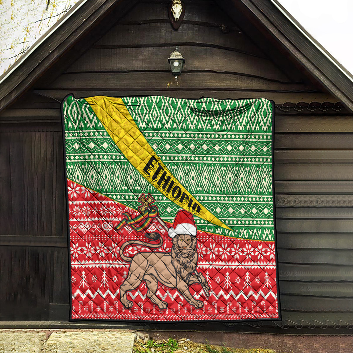 Ethiopian Christmas quilt hanging outdoors: green geometric top, red bottom, lion center