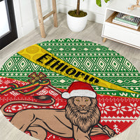 Round area rug with green geometric pattern, yellow 'Ethiopia' text, lion in Santa hat