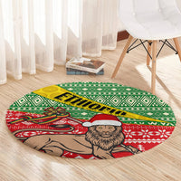Round area rug with green lattice pattern, red border, lion with white Santa hat