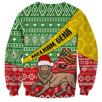 Unisex Christmas sweatshirt with green geometric pattern, yellow band, and 'MELKAM GENA' print