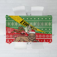 Christmas tablecloth with green, red, and white geometric border and camel pattern