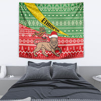 African Christmas tapestry showing lion figure with Santa hat on green and red pattern