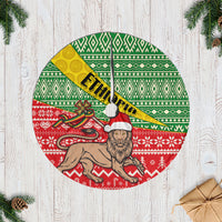 Christmas tree skirt with green, red, yellow African pattern and white fringe
