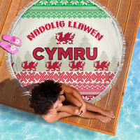 Round beach blanket shown from above with CYMRU text, red Welsh dragon pattern, fringe