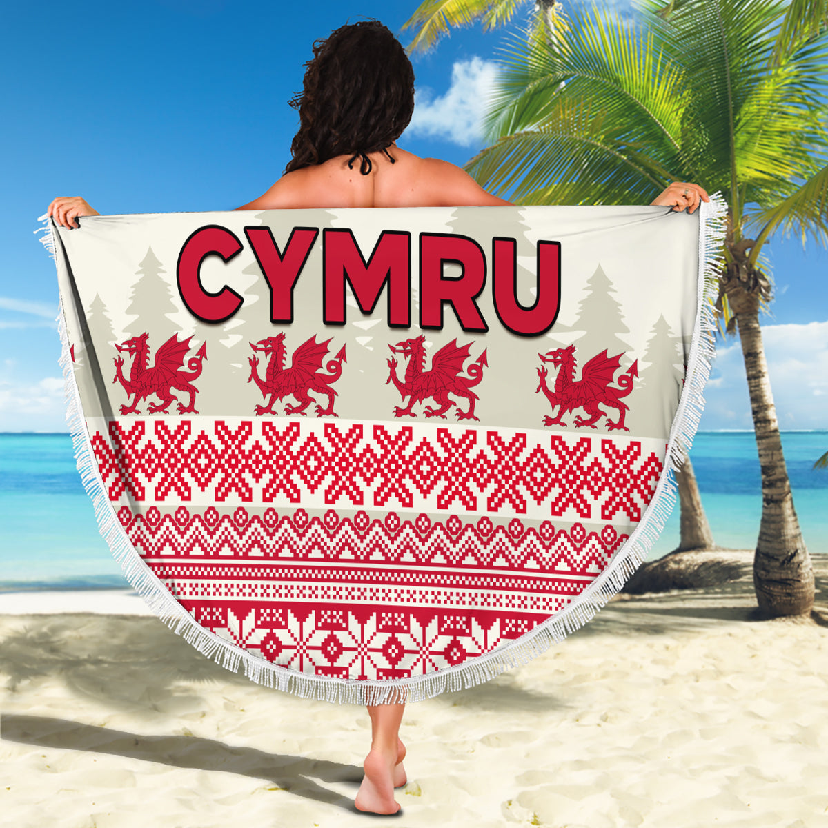Round beach blanket held up: CYMRU text with red Welsh dragons and green pattern, fringed