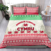 Holiday Christmas bedding set on bed, white duvet with red green Welsh dragon motif and pillows