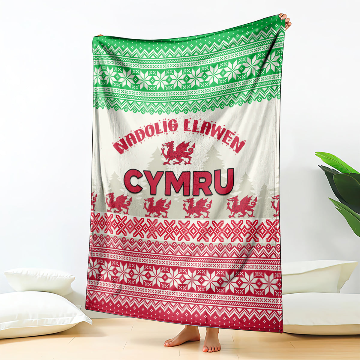 Christmas blanket with green and red knit pattern and Welsh dragon graphic on white background