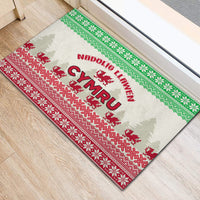 Christmas rubber doormat with centered 'Cymru' text and Welsh dragon on green/red pattern