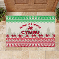 Christmas rubber doormat with Welsh dragon, 'Nadolig Llawen', and evergreen icons in green/red