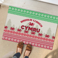 Christmas rubber doormat with 'Nadolig Llawen Cymru' text and Welsh dragon in green/red