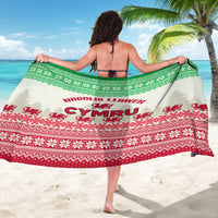 Back view of green and red Christmas sarong with dragon emblem and border pattern