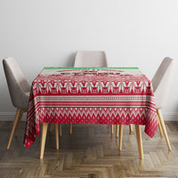 Christmas tablecloth covering dining table, red base with white geometric pattern