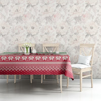 Christmas tablecloth with red and white pattern and green top border on table