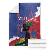 Folded blue and red Polynesian-pattern blanket with silhouette and hibiscus flowers