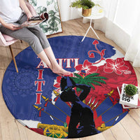 Blue round Haiti-themed carpet with red floral, dark silhouette figures, spears and wheel motifs