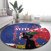 Blue round carpet showing Haiti lettering, red hibiscus, dark figure silhouette and oar wheel designs