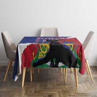 Tablecloth on dining table with red and blue pattern and black animal silhouette