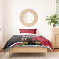 Bedding set on bed with red, black, and white patterned duvet and two pillowcases