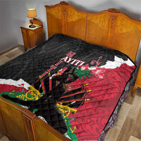Quilted bedspread blanket with black quilted texture, red side, and Polynesian-style graphics
