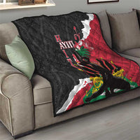 Quilted throw blanket on living room sofa, black and red Polynesian-style pattern with flowers